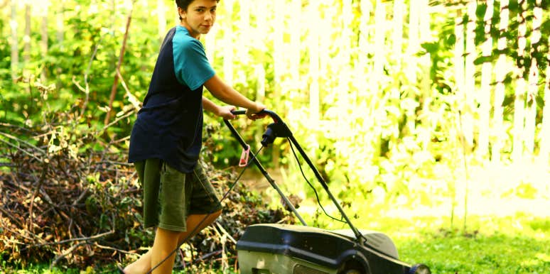 teenage son using a lawnmower