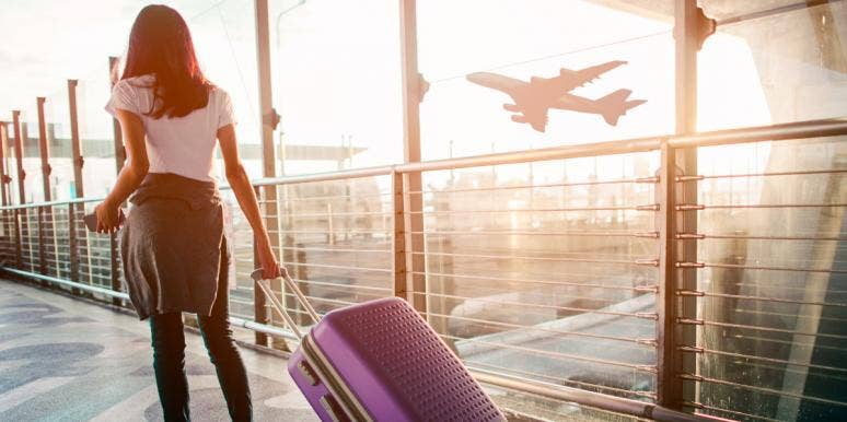 Why It Took Leaving The Country To Finally Get Over My Ex woman with suitcase traveling