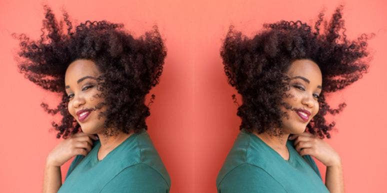 13 Best & Worst Leo Personality Traits smiling woman with hair blowing