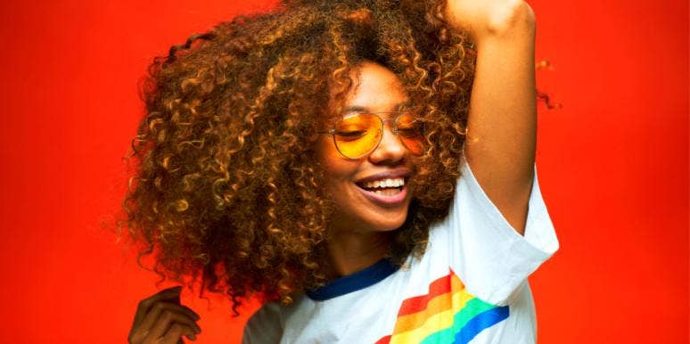 happy woman wearing rainbow shirt