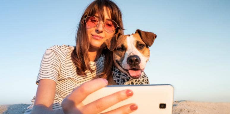 10 Best & Worst Libra Personality Traits woman taking selfie with dog