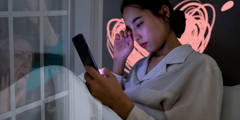 WOman sad on phone in bed