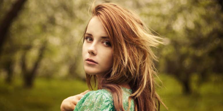 how to function through cumulative grief young strawberry blonde woman outdoors looking serious