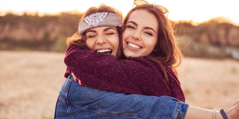 The Harsh Reality Of Losing Your Best Friend To Their Boyfriend two friends smiling hugging