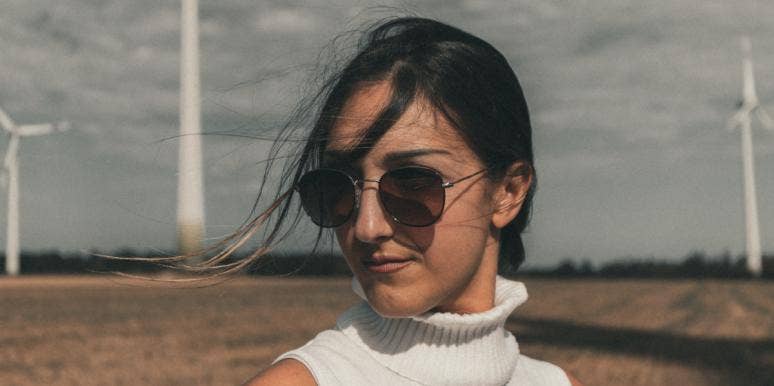 How I Learned To Finally Love My Brown Skin woman with sunglasses standing in field