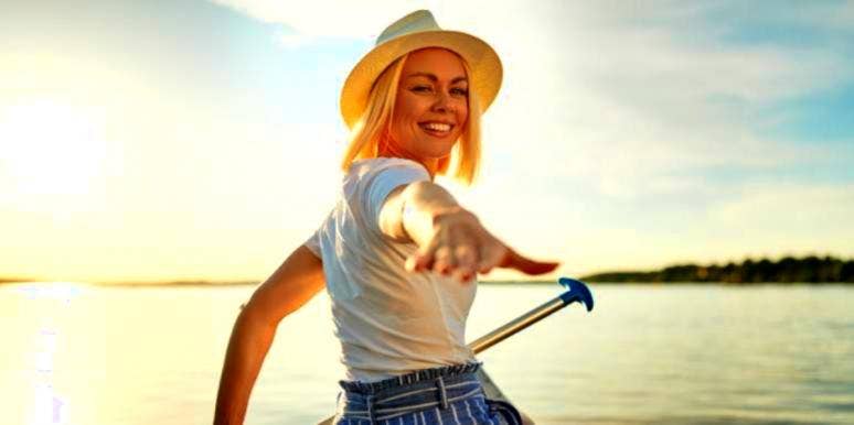 What Your Life Line & Heart Line Say About Love Compatibility woman holding out hand to her love