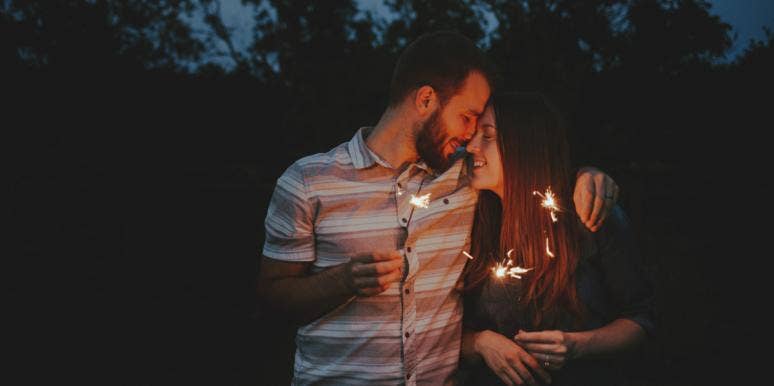 Real Love Doesn't Always Have A Spark, So Stop Waiting For One couple holding sparklers