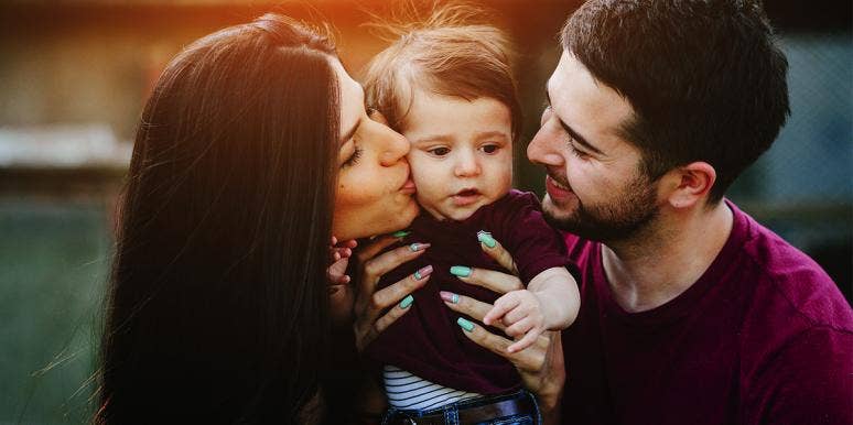 If You Love Your Kids More Than Your Husband, You're Doing It Wrong mom and dad holding baby