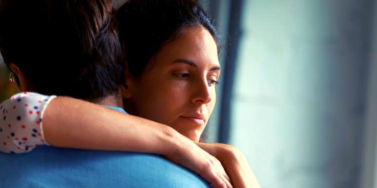 How To Know If You're In A Loveless Marriage unhappy woman with her arm around her husband