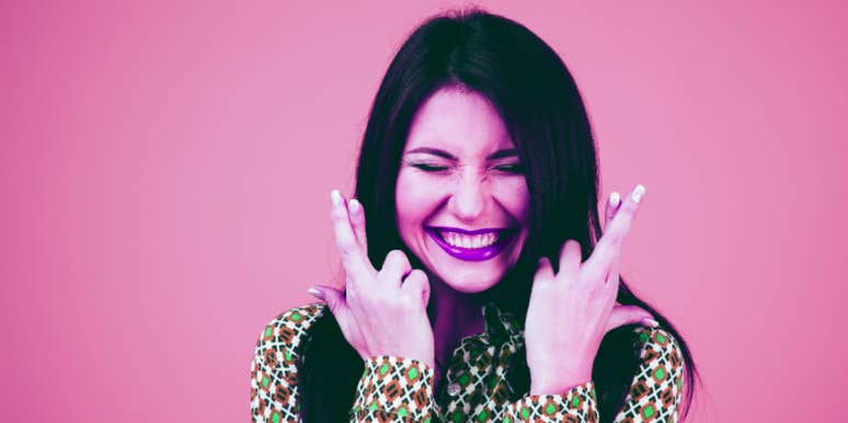 The Luckiest Zodiac Signs, Ranked woman crossing her fingers