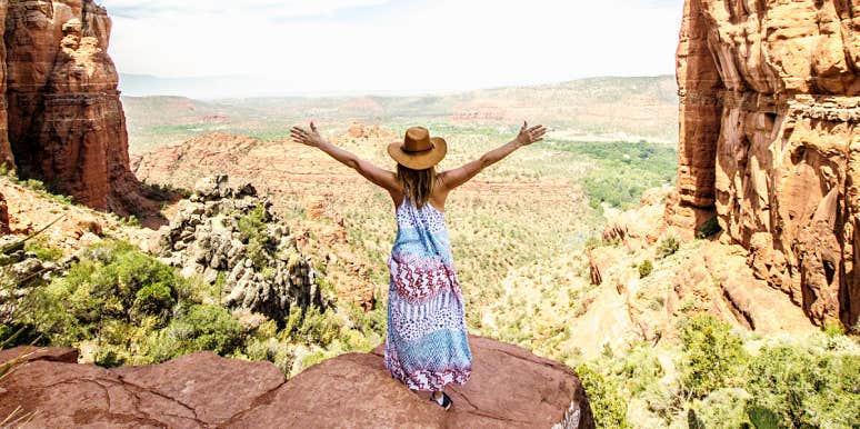 Tap into your magical silver lining vortex for a bad day woman standing in Sonoma, arms out joyfully, wearing a sundress
