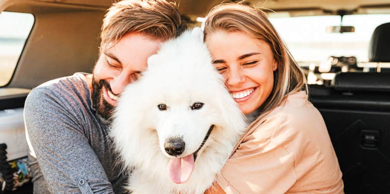 Make friends with dog Couple hugging pretty dog