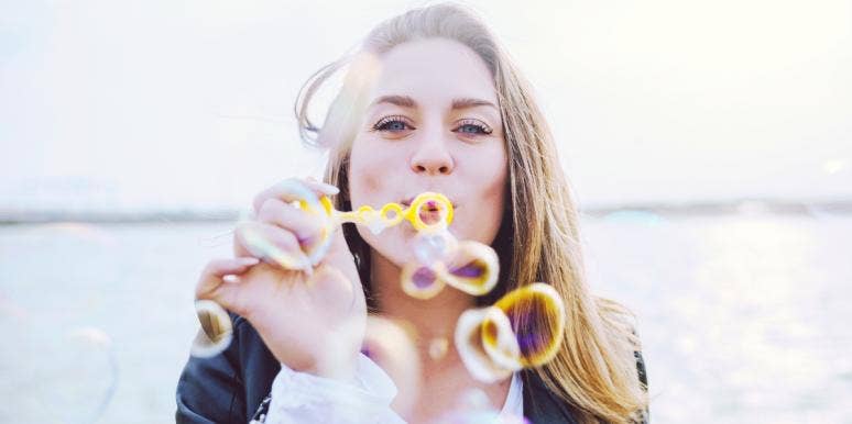 make it to your goals woman blowing bubbles