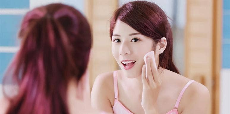 This Viral Before/After Make-Up Removal Video Is Insane woman putting on makeup in mirror