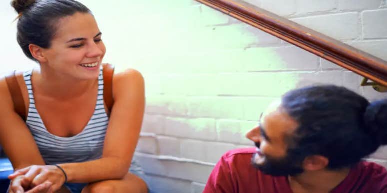 Men Reveal The 7 Most Common Insecurities For Guys (That Women Don't Even Realize) woman and man looking at each other in discussion on staircase
