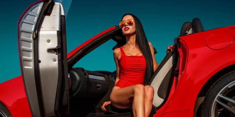 woman in red sports car
