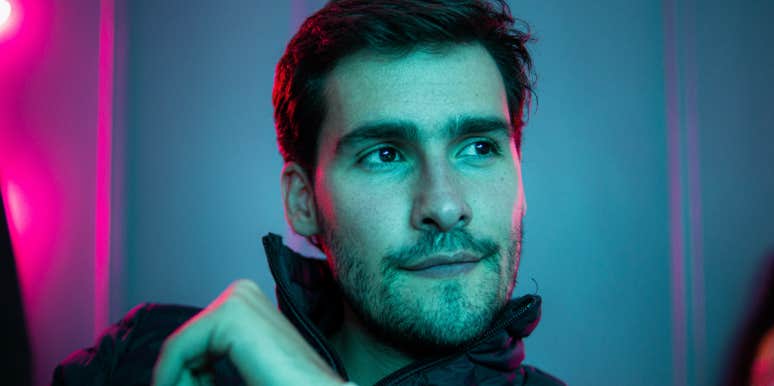 Man Tells Fiancée He Won't Take A DNA Test After She Believes They May Be Related Man staring off-screen with neon background
