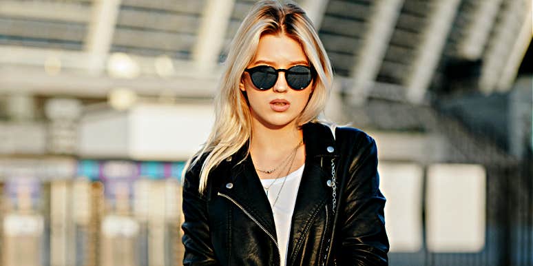 young woman looks nervous in sunglasses