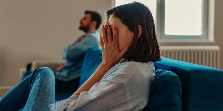 Married Couple Habits That Inevitably Lead To Divorce woman putting hand over eyes next to man on couch