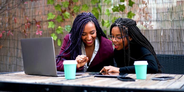 Mentor skills African-American Woman works with younger woman