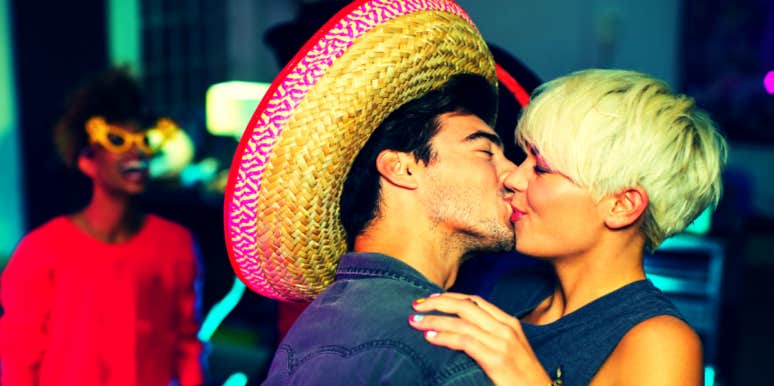 The 20 Best Mexican Love Songs To Play On Cinco De Mayo woman kissing man in a sombrero