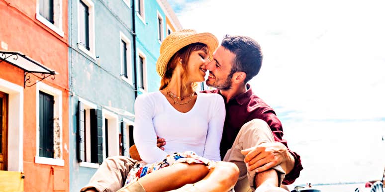Memetic desire in relationships couple kissing along canal