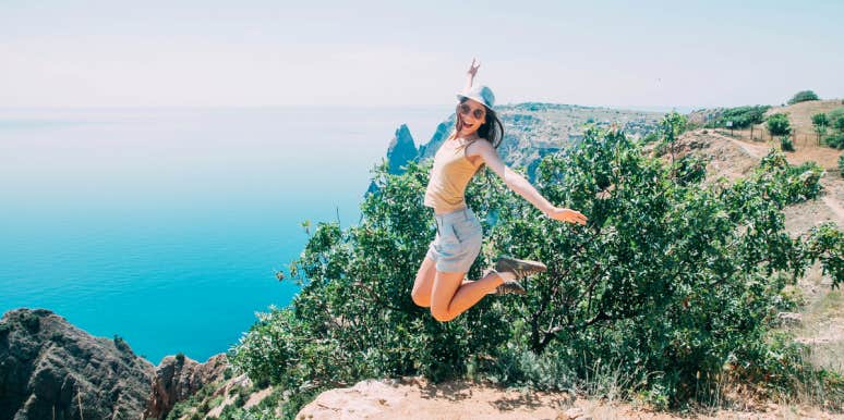 woman jumping on mountain