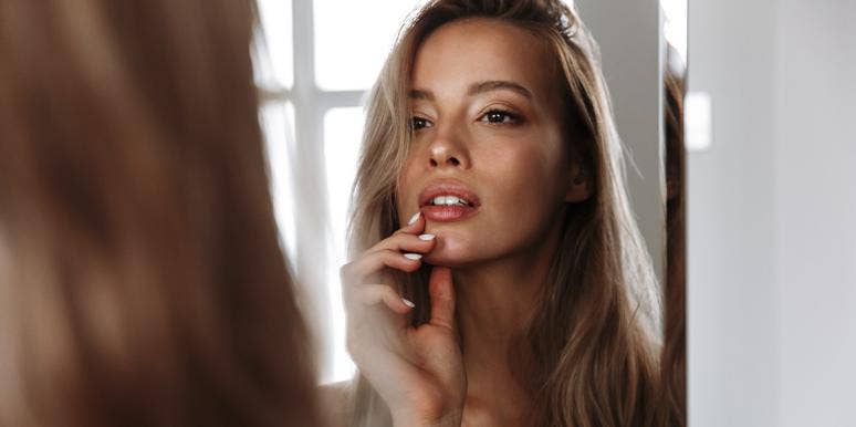 How I Radically Reclaimed My Body From The Religion That "Owned" It woman looking into mirror