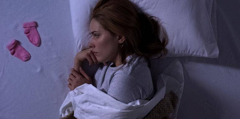 6 Things I've Learned From 3 Miscarriages In 9 Months woman crying on bed