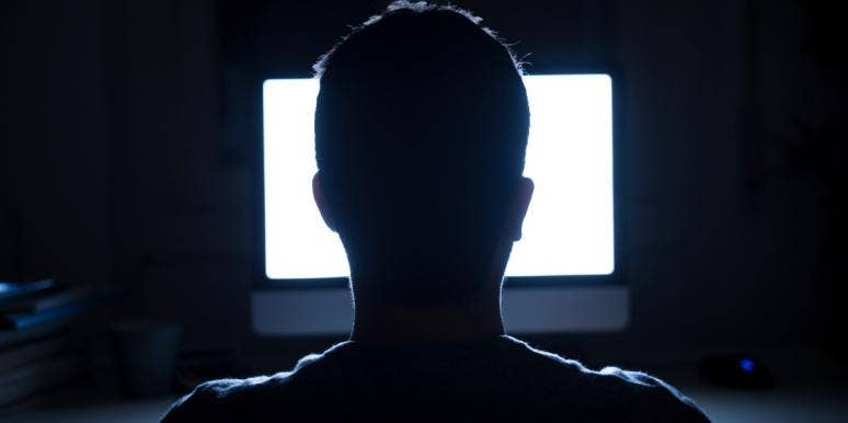 What Is The Difference Between Misinformation Vs. Disinformation? silhouette of man sitting in front of a lit computer screen