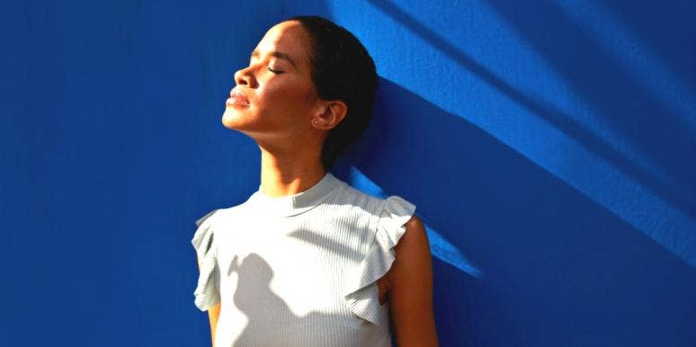 The Saddest Zodiac Signs That Are Most Likely To Be Depressed woman looking up at light