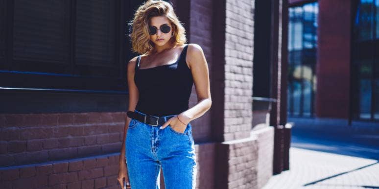 woman in sunglasses high waist jeans