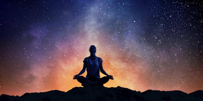 person meditating night sky