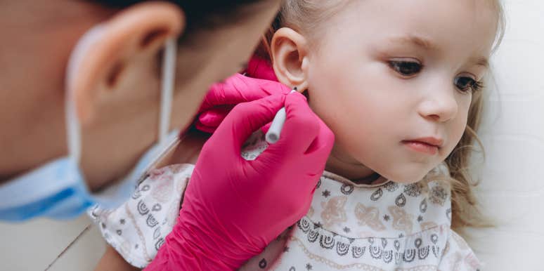 Mother Reconsiders Custody Agreement After Ex Pierces Their Daughters Ears Without Her Permission little girl getting her ears pierced