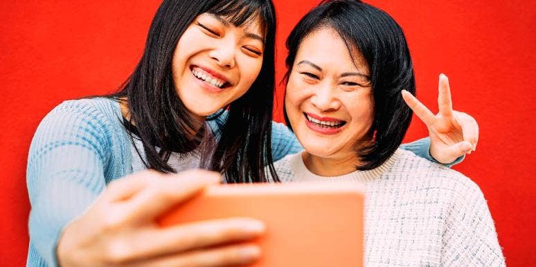 mom and daughter posing for selfie together
