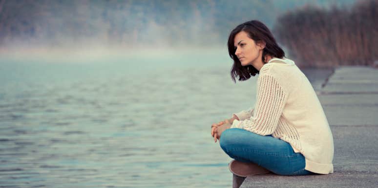 woman sitting alone looking into distance