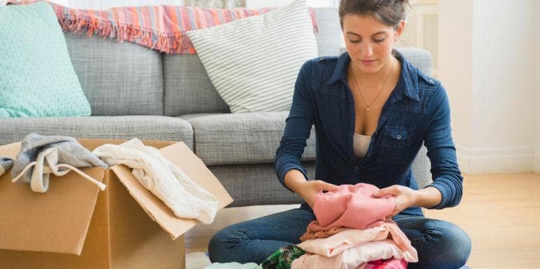 moving during a pandemic woman packing clothes in a box