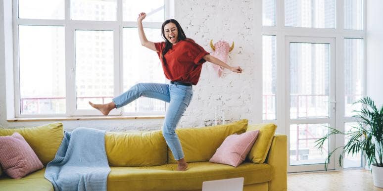 woman jumping on couch