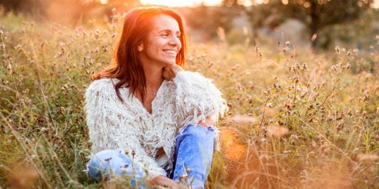 8 Fascinating Cancer Zodiac Facts About The Unique Sign woman smiling in a field