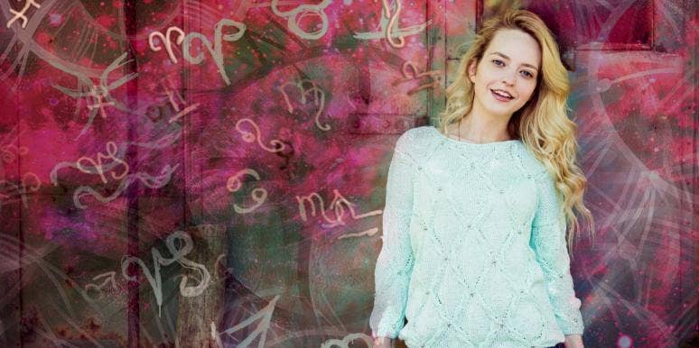 natal charts woman standing by wall with astrology signs
