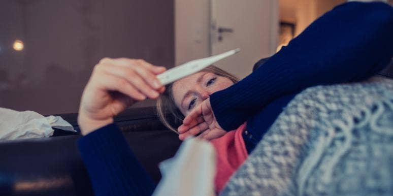 natural medicines for autumn ailments sick woman checking her temperature