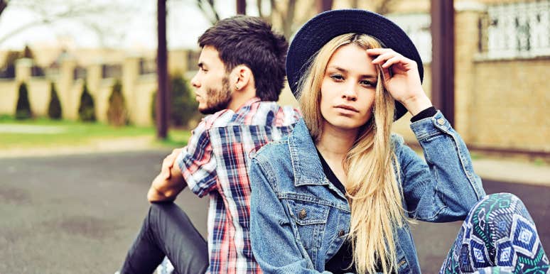 Needy emotionally unavailable Woman and man sit back to back ignoring each other