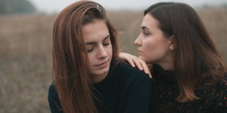 We'll Never Be Friends Again And That's Okay two friends leaning on each other