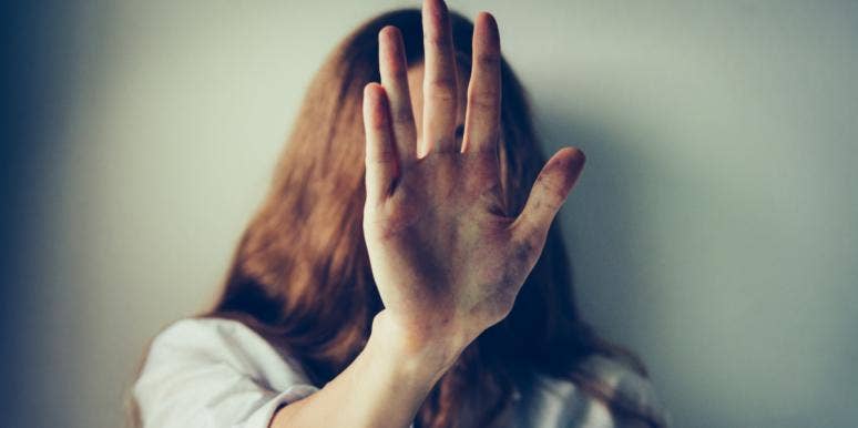 I Never Told You I Was In An Abusive Relationship, Because I Didn't Know I Was woman with hand in front of face