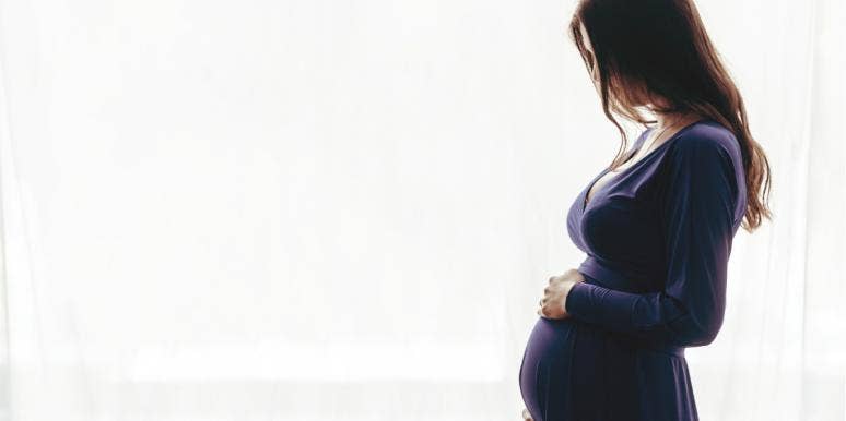 pregnant woman dressed in purple