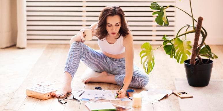 New Year's Vision board woman on the floor creating a vision board