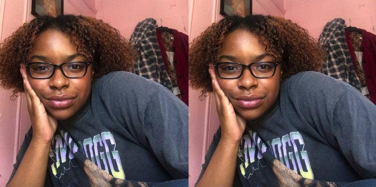 Nia Tipton, a young Black woman, smiles with her chin in her hand Nia Tipton