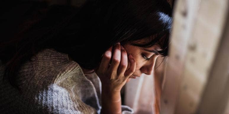 Let's Normalize 'It's Okay Not To Be Okay' For Our Anxious Friends woman looking down