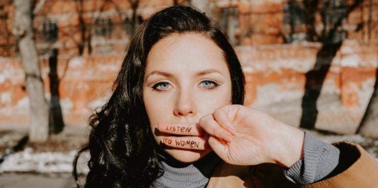 Why I’m A Woman Who Has The Right To Not Be A Feminist woman with hand over her mouth