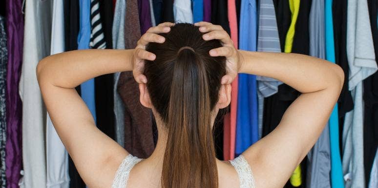100 Best Organizing Tips & Ideas for Easy Home Organization frustrated woman with hands on head in front of clothing in closet